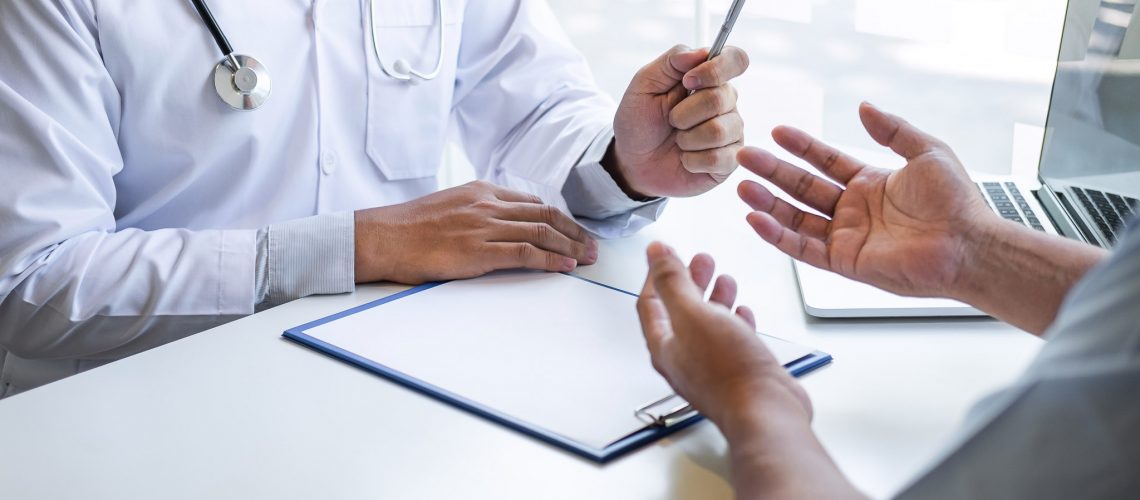 Doctor and patient are discussing consultation about symptom problem diagnosis of disease talk to the patient about medication and treatment method.